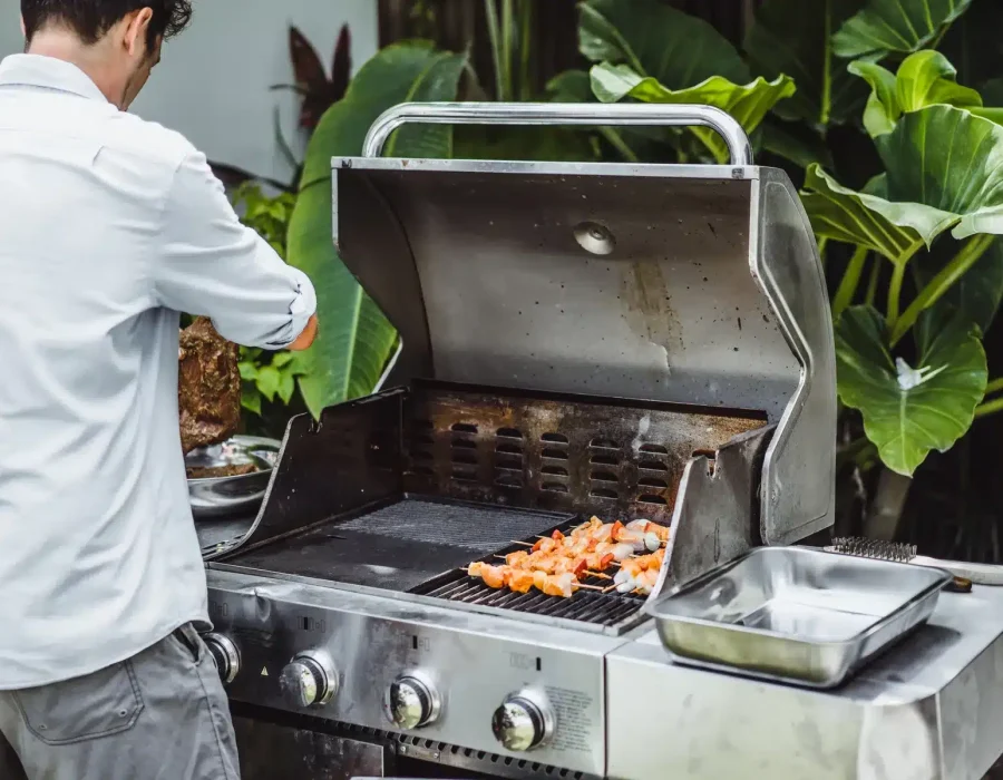 man-tattoos-makes-barbecue-grill-meat-outdoors