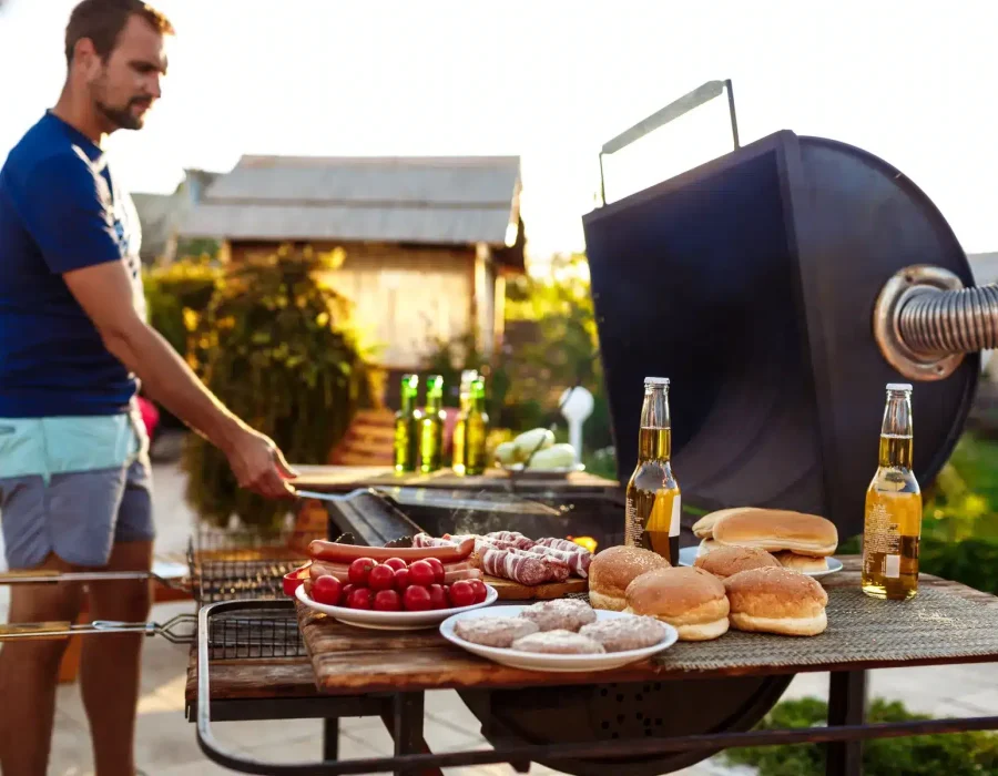 young-man-roasting-barbecue-grill-cottage-countryside