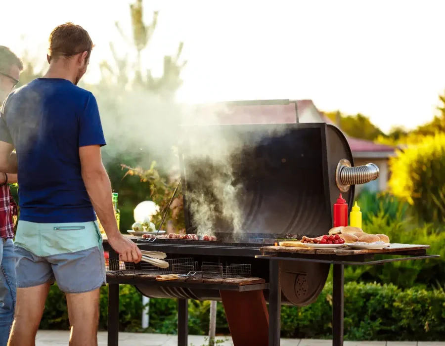 young-men-roasting-barbecue-grill-cottage-countryside